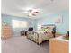 Comfortable bedroom featuring a ceiling fan, floral bedding and furnishings at 8710 Sw 91St St # E, Ocala, FL 34481