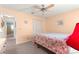 Bedroom with a ceiling fan and a comfortable bed with floral bedding at 8710 Sw 91St St # E, Ocala, FL 34481