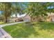 Landscaped lawn of a single-story home that has a long driveway and beautiful shade trees at 8710 Sw 91St St # E, Ocala, FL 34481