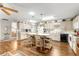Bright kitchen with breakfast bar island, wood floors, and hanging pendant lights at 8710 Sw 91St St # E, Ocala, FL 34481