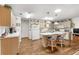 Bright kitchen with breakfast bar island, wood floors, and adjacent living room at 8710 Sw 91St St # E, Ocala, FL 34481