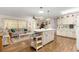 Open floor plan with combined kitchen/living area, breakfast bar, wood flooring and large windows at 8710 Sw 91St St # E, Ocala, FL 34481