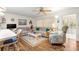 Living room featuring wood floors, ceiling fan, breakfast bar and open to sun room at 8710 Sw 91St St # E, Ocala, FL 34481
