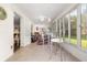 Bright sunroom with tile flooring, floor-to-ceiling windows, and a cozy seating area at 8710 Sw 91St St # E, Ocala, FL 34481