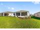 Lush green backyard featuring a screened lanai, landscaping, and room to roam at 8816 Sw 69Th Place Rd, Ocala, FL 34481