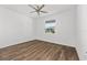 Bedroom with ceiling fan, wood-look flooring, and a window at 8816 Sw 69Th Place Rd, Ocala, FL 34481