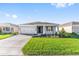 Charming single-story home boasts a well-manicured lawn, two-car garage, and welcoming front entrance at 8816 Sw 69Th Place Rd, Ocala, FL 34481