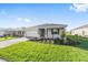 A single-story house showcases well-maintained landscaping, a two-car garage, and a welcoming facade at 8816 Sw 69Th Place Rd, Ocala, FL 34481