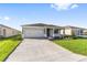 Charming single-story home with a two-car garage, well-manicured lawn, and professionally landscaped front yard at 8816 Sw 69Th Place Rd, Ocala, FL 34481