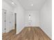 Bright and airy foyer with wood-look floors and white walls, showcasing the home's modern design at 8816 Sw 69Th Place Rd, Ocala, FL 34481
