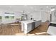 Open-concept kitchen featuring a large island with seating, stainless steel appliances, and plenty of natural light at 8816 Sw 69Th Place Rd, Ocala, FL 34481