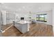 Open-concept kitchen and living area with gray cabinets, quartz countertops and stainless appliances at 8816 Sw 69Th Place Rd, Ocala, FL 34481