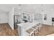 Modern kitchen with a large center island, quartz countertops, stylish gray cabinets, and stainless appliances at 8816 Sw 69Th Place Rd, Ocala, FL 34481