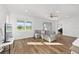Comfortable living room with wood floors and bright natural light from the large window at 8816 Sw 69Th Place Rd, Ocala, FL 34481