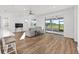 Open living room features wood flooring and sliding glass doors to the lanai at 8816 Sw 69Th Place Rd, Ocala, FL 34481