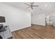 Bright living room with wood-look floors open to kitchen with gray cabinets at 8816 Sw 69Th Place Rd, Ocala, FL 34481