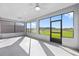 Enclosed patio featuring large windows for natural light and views of the expansive green lawn at 8816 Sw 69Th Place Rd, Ocala, FL 34481