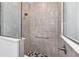 Tiled shower with black and gray mosaic tile floor and glass door at 8816 Sw 69Th Place Rd, Ocala, FL 34481