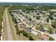 This aerial view highlights a community close to the main highway with lush greenery and neatly arranged homes at 8849 Sw 116Th Place Rd, Ocala, FL 34481