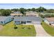 Aerial view of a charming single-story home with a well-manicured lawn and driveway at 8849 Sw 116Th Place Rd, Ocala, FL 34481