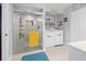 Well-lit bathroom and laundry room featuring a walk-in shower and laundry appliances at 8849 Sw 116Th Place Rd, Ocala, FL 34481