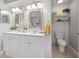 Bathroom showcasing double sinks, shiplap walls, and updated lighting fixtures at 8849 Sw 116Th Place Rd, Ocala, FL 34481