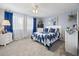 Cozy bedroom with soft carpet, a matching bedding set, bedside tables, and a bright window at 8849 Sw 116Th Place Rd, Ocala, FL 34481