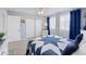 Comfortable bedroom featuring a ceiling fan, carpet, and white closet doors at 8849 Sw 116Th Place Rd, Ocala, FL 34481