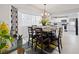Inviting dining room with modern decor, chandelier, and plenty of natural light at 8849 Sw 116Th Place Rd, Ocala, FL 34481