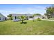 Inviting single-story home with a lush front lawn, palm trees, and well-maintained landscaping at 8849 Sw 116Th Place Rd, Ocala, FL 34481