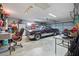 Spacious garage featuring a classic car, ample storage, and workspace for projects at 8849 Sw 116Th Place Rd, Ocala, FL 34481