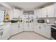 Well-lit kitchen showcasing white cabinetry, contemporary finishes, and a functional layout at 8849 Sw 116Th Place Rd, Ocala, FL 34481