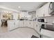 Open kitchen with modern white cabinets, stainless steel appliances, and neutral countertops at 8849 Sw 116Th Place Rd, Ocala, FL 34481