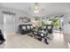 Inviting living room featuring modern decor, tile floors, comfortable leather sofas, and abundant natural light from the windows at 8849 Sw 116Th Place Rd, Ocala, FL 34481