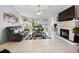 Bright open-concept living area with tile flooring, a modern fireplace, and sliding glass doors to the backyard at 8849 Sw 116Th Place Rd, Ocala, FL 34481