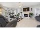Open living room featuring a cozy fireplace, tile floors, and a view of the sliding glass doors to the backyard at 8849 Sw 116Th Place Rd, Ocala, FL 34481