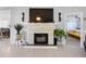 Living room featuring a modern fireplace and decorative sconces, with a dining area visible in the background at 8849 Sw 116Th Place Rd, Ocala, FL 34481