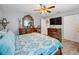 Bedroom featuring a ceiling fan, carpet, and an ornate dresser with a large mirror at 8849 Sw 116Th Place Rd, Ocala, FL 34481
