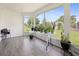 Enclosed sunroom with durable flooring and walls of windows overlooking a well-manicured lawn at 8849 Sw 116Th Place Rd, Ocala, FL 34481