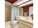 Bathroom featuring red accent wall, updated vanity, lighting, and soaking tub with shower at 8926 Sw 192Nd Court Rd, Dunnellon, FL 34432