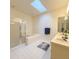Bathroom featuring double sinks, walk-in shower, soaking tub, skylight, and tiled floors at 8926 Sw 192Nd Court Rd, Dunnellon, FL 34432
