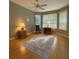 Light filled bedroom with neutral paint, hardwood flooring, and bay windows with views at 8926 Sw 192Nd Court Rd, Dunnellon, FL 34432