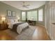 Cozy bedroom with a large bed, bay windows, and hardwood flooring and soft, neutral paint at 8926 Sw 192Nd Court Rd, Dunnellon, FL 34432