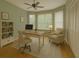 Comfortable home office space featuring hardwood floors, light neutral paint, and lots of light at 8926 Sw 192Nd Court Rd, Dunnellon, FL 34432