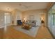 Bright living room with hardwood floors, neutral walls, and sliding glass doors to a patio at 8926 Sw 192Nd Court Rd, Dunnellon, FL 34432
