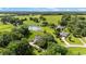 Aerial view highlighting the expansive property, featuring a pond and lush green pastures surrounding the house at 8940 Sw 8Th St, Ocala, FL 34481