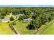 Aerial view of a serene property featuring lush landscaping and a sparkling pool at 8940 Sw 8Th St, Ocala, FL 34481