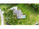 Aerial view of a private home featuring a screened pool, driveway, and lush green landscaping at 8940 Sw 8Th St, Ocala, FL 34481