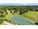 Beautiful aerial view of properties with a pond and horse pasture surrounded by lush trees at 8940 Sw 8Th St, Ocala, FL 34481
