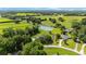 Aerial view of the property, showcasing a large pond, mature trees and a serene setting at 8940 Sw 8Th St, Ocala, FL 34481